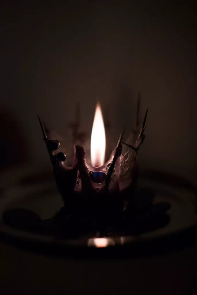 Love spell on black candle and needles